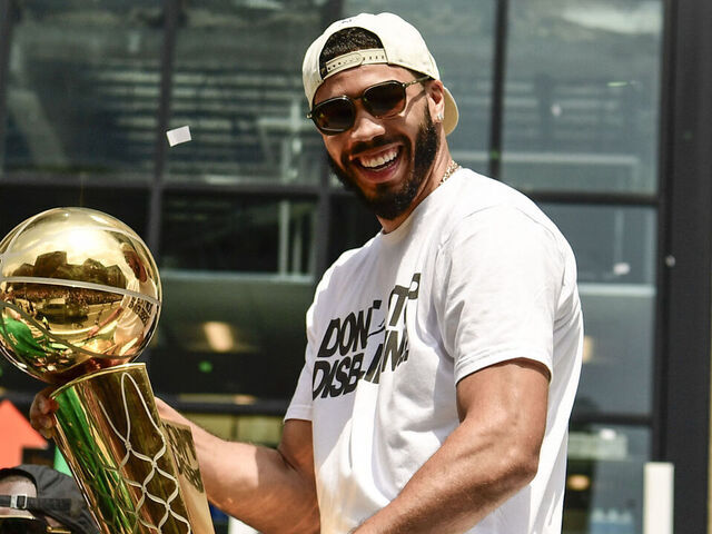BOSTON, MASSACHUSETTS - JUNE 21: Jason Tatum #0 of the Boston Celtics reacts as he holds the Larry O'Brien Championship Trophy during the 2024 Boston Celtics championship parade following their 2024 NBA Finals win on June 21, 2024 in Boston, Massachusetts.