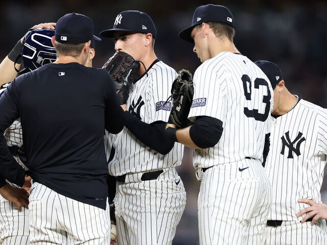 NEW YORK, NEW YORK - JUNE 19: Ron Marinaccio #97 of the New York Yankees receives a mound visit against the Baltimore Orioles at Yankee Stadium on June 19, 2024 in the Bronx borough of New York City.