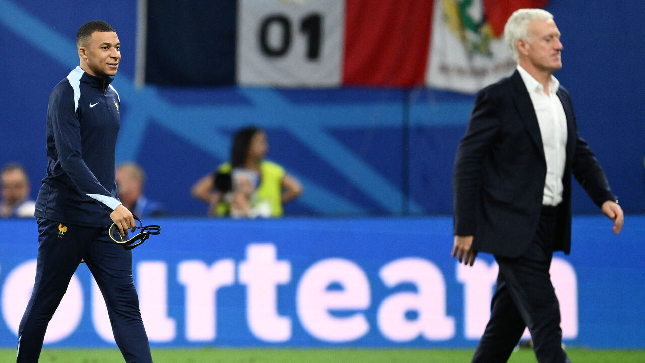 (From L) France's forward #10 Kylian Mbappe and France's head coach Didier Deschamps react at the end of the UEFA Euro 2024 Group D football match between the Netherlands and France at the Leipzig Stadium in Leipzig on June 21, 2024.