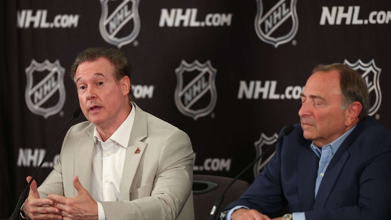 PHOENIX, ARIZONA - APRIL 19: Coyotes Chairman and Governor Alex Meruelo (L) speaks alongside NHL Commissioner Gary Bettman during a press conference at Hyatt Regency Phoenix on April 19, 2024 in Phoenix, Arizona. The NHL unanimously approved a $1.2 billion sale from Alex Meruelo to Utah Jazz owners Ryan and Ashley Smith, allowing the franchise's move to Salt Lake City to begin play as a new franchise next season.