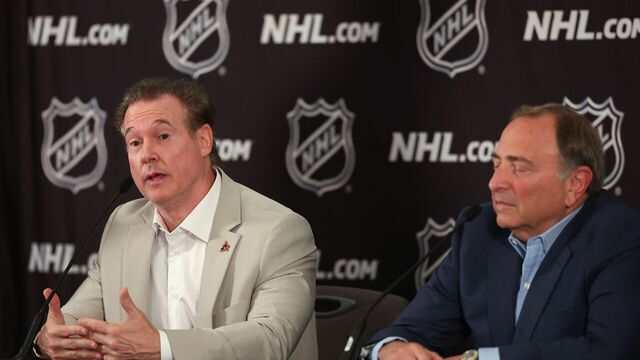 PHOENIX, ARIZONA - APRIL 19: Coyotes Chairman and Governor Alex Meruelo (L) speaks alongside NHL Commissioner Gary Bettman during a press conference at Hyatt Regency Phoenix on April 19, 2024 in Phoenix, Arizona. The NHL unanimously approved a $1.2 billion sale from Alex Meruelo to Utah Jazz owners Ryan and Ashley Smith, allowing the franchise's move to Salt Lake City to begin play as a new franchise next season.
