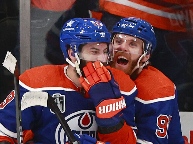 EDMONTON, ALBERTA - JUNE 21: Connor McDavid #97 and Adam Henrique #19 of the Edmonton Oilers celebrate their win over the Florida Panthers during the third period of Game Six of the 2024 Stanley Cup Final at Rogers Place on June 21, 2024 in Edmonton, Alberta.