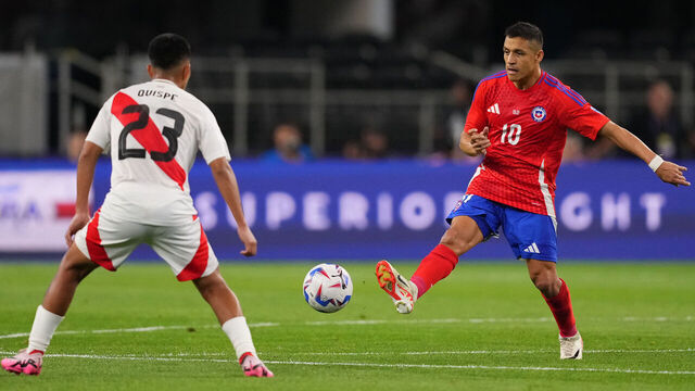 ARLINGTON, TEXAS - JUNE 21: Alexis Sanchez of Chile kicks the ball against Piero Quispe of Peru during the CONMEBOL Copa America 2024 Group A match between Peru and Chile at AT&T Stadium on June 21, 2024 in Arlington, Texas.