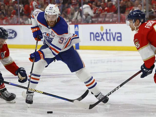 SUNRISE, FLORIDA - JUNE 18: Connor McDavid #97 of the Edmonton Oilers skates between teammates Aleksander Barkov #16 and Gustav Forsling #42 of the Florida Panthers in Game Five of the Stanley Cup Final at the Amerant Bank Arena on June 18, 2024 in Sunrise, Florida.