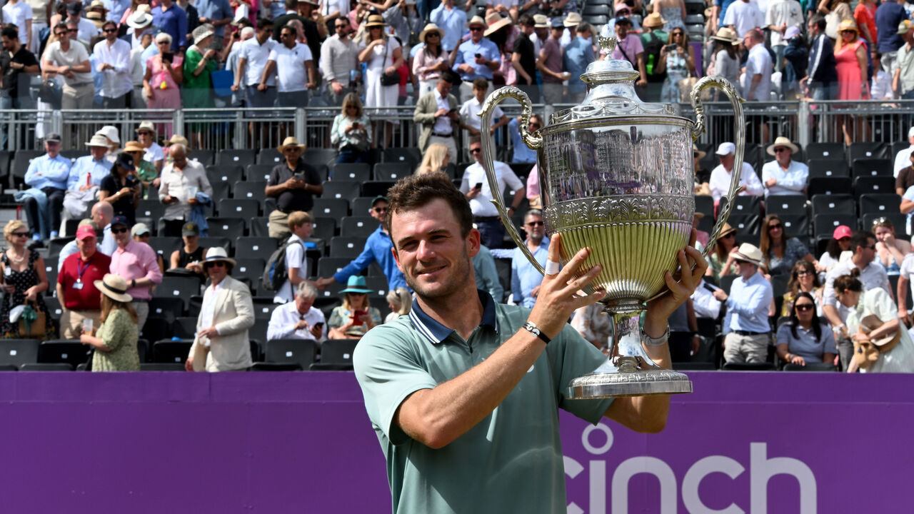 LONDON, ENGLAND - JUNE 23: Tommy Paul of USA lifts the trophy after winning against Lorenzo Musetti of Italy in the mens singles finals at The Queen's Club on June 23, 2024 in London, England.