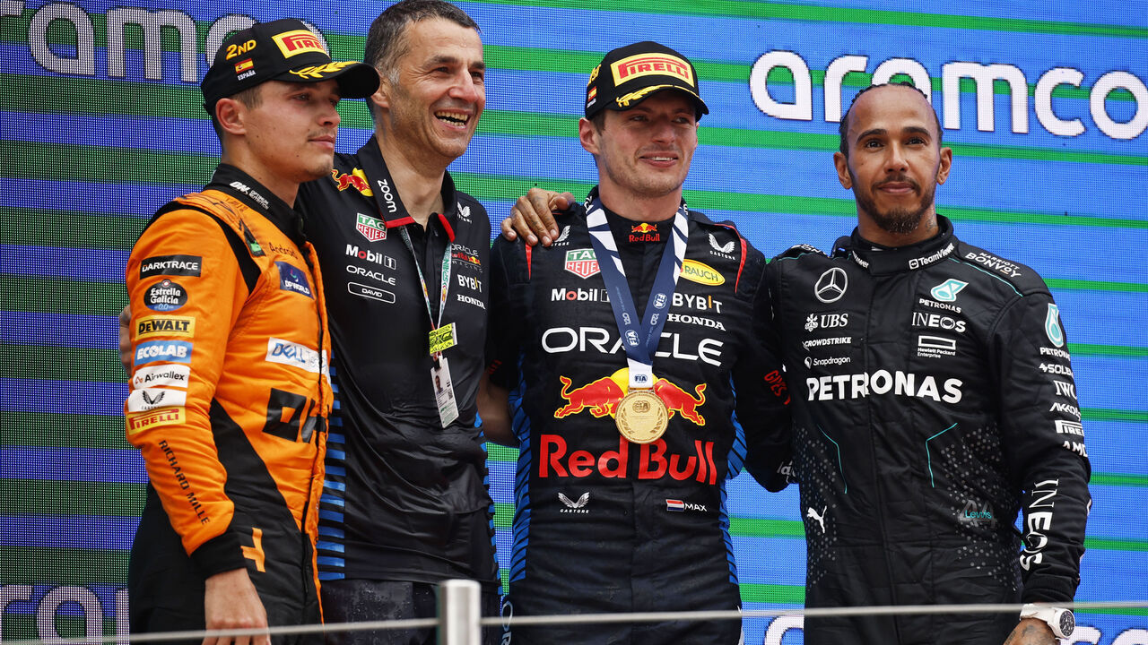 BARCELONA, SPAIN - JUNE 23: Race winner Max Verstappen of the Netherlands and Oracle Red Bull Racing, Second placed Lando Norris of Great Britain and McLaren, Third placed Lewis Hamilton of Great Britain and Mercedes and David Jackson, Oracle Red Bull Racing Systems Design Group Leader celebrate on the podium during the F1 Grand Prix of Spain at Circuit de Barcelona-Catalunya on June 23, 2024 in Barcelona, Spain.
