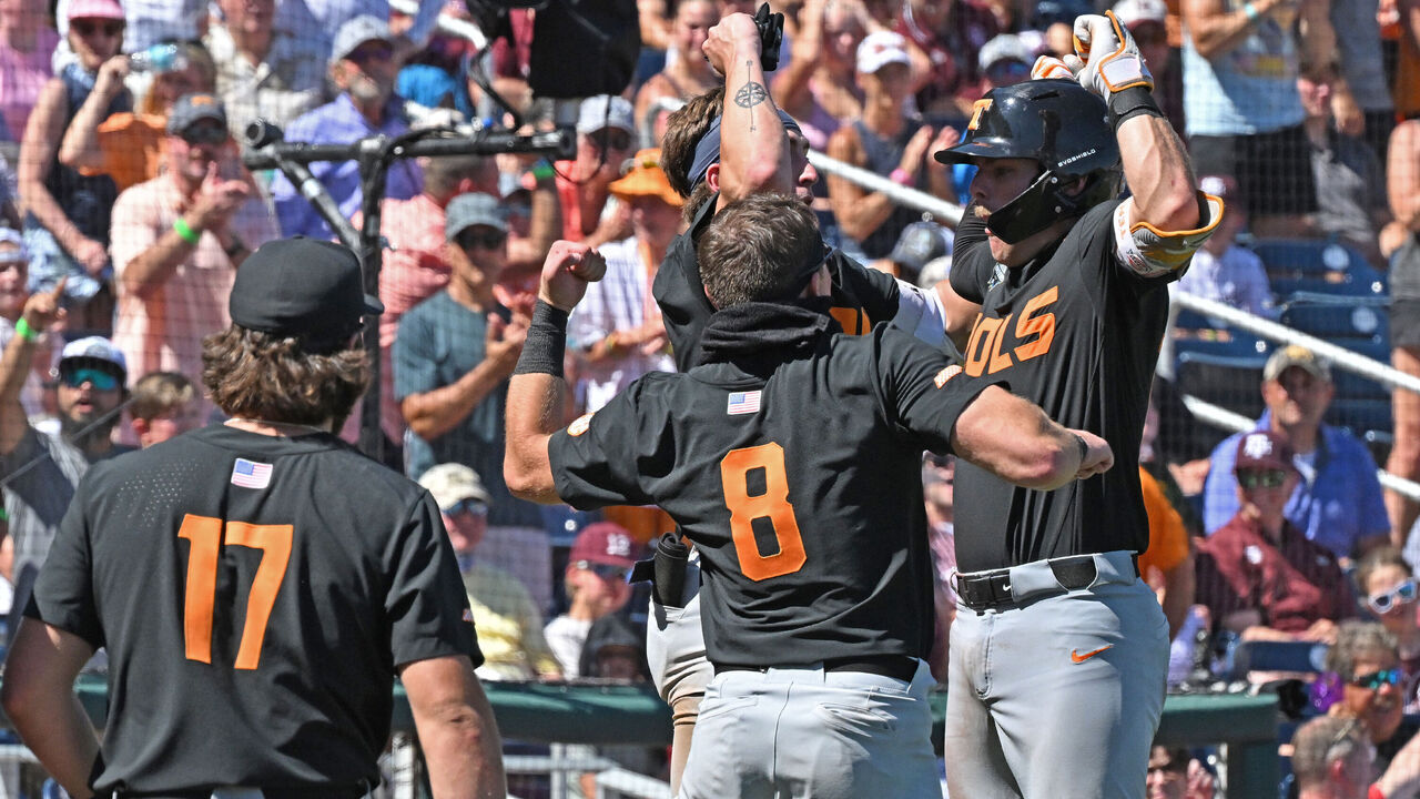 OMAHA, NE - JUNE 23: Cal Stark (R) of the Tennessee Volunteers celebrates with his teammates after hitting a two-run home run in the eighth inning against the Texas A&M Aggies during the NCAA Division I Baseball Championship on June 23, 2024 at Charles Schwab Field in Omaha, Nebraska.
