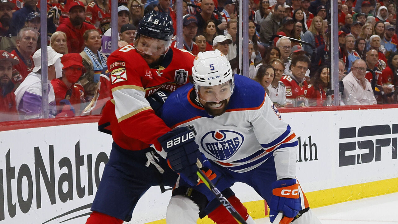 SUNRISE, FLORIDA - JUNE 24: Cody Ceci #5 of the Edmonton Oilers collides into Kyle Okposo #8 of the Florida Panthers during the first period of game Game Seven of the 2024 Stanley Cup Final at Amerant Bank Arena on June 24, 2024 in Sunrise, Florida.