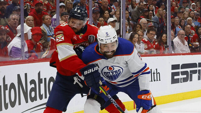 SUNRISE, FLORIDA - JUNE 24: Cody Ceci #5 of the Edmonton Oilers collides into Kyle Okposo #8 of the Florida Panthers during the first period of game Game Seven of the 2024 Stanley Cup Final at Amerant Bank Arena on June 24, 2024 in Sunrise, Florida.