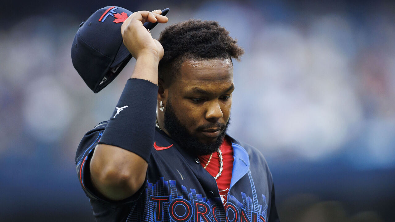 TORONTO, CANADA - JUNE 19: Vladimir Guerrero Jr. #27 of the Toronto Blue Jays takes off his hat as he walks to the dugout in the first inning of their MLB game against the Boston Red Sox at Rogers Centre on June 19, 2024 in Toronto, Ontario, Canada.