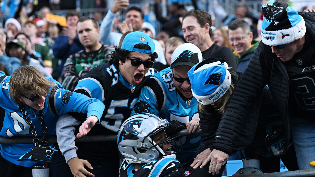 CHARLOTTE, NORTH CAROLINA - DECEMBER 24: DJ Chark Jr. #17 of the Carolina Panthers celebrates with fans after scoring a touchdown during the fourth quarter against the Green Bay Packers at Bank of America Stadium on December 24, 2023 in Charlotte, North Carolina.