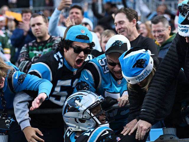 CHARLOTTE, NORTH CAROLINA - DECEMBER 24: DJ Chark Jr. #17 of the Carolina Panthers celebrates with fans after scoring a touchdown during the fourth quarter against the Green Bay Packers at Bank of America Stadium on December 24, 2023 in Charlotte, North Carolina.