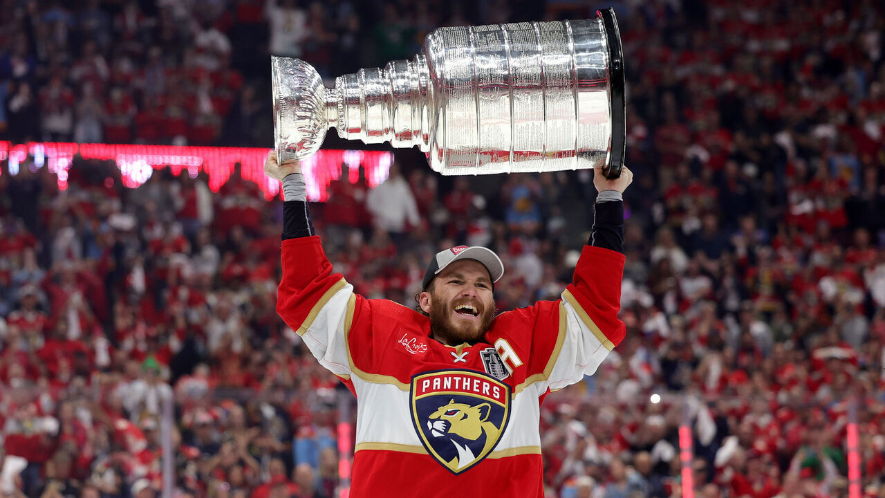 SUNRISE, FLORIDA - JUNE 24: Matthew Tkachuk #19 of the Florida Panthers lifts the Stanley Cup after Florida's 2-1 victory against the Edmonton Oilers in Game Seven of the 2024 Stanley Cup Final at Amerant Bank Arena on June 24, 2024 in Sunrise, Florida.