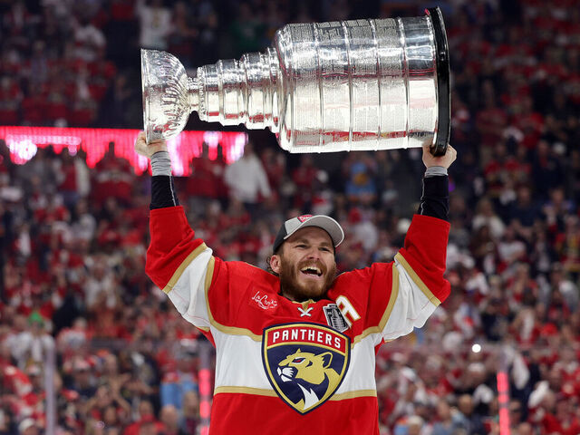 SUNRISE, FLORIDA - JUNE 24: Matthew Tkachuk #19 of the Florida Panthers lifts the Stanley Cup after Florida's 2-1 victory against the Edmonton Oilers in Game Seven of the 2024 Stanley Cup Final at Amerant Bank Arena on June 24, 2024 in Sunrise, Florida.