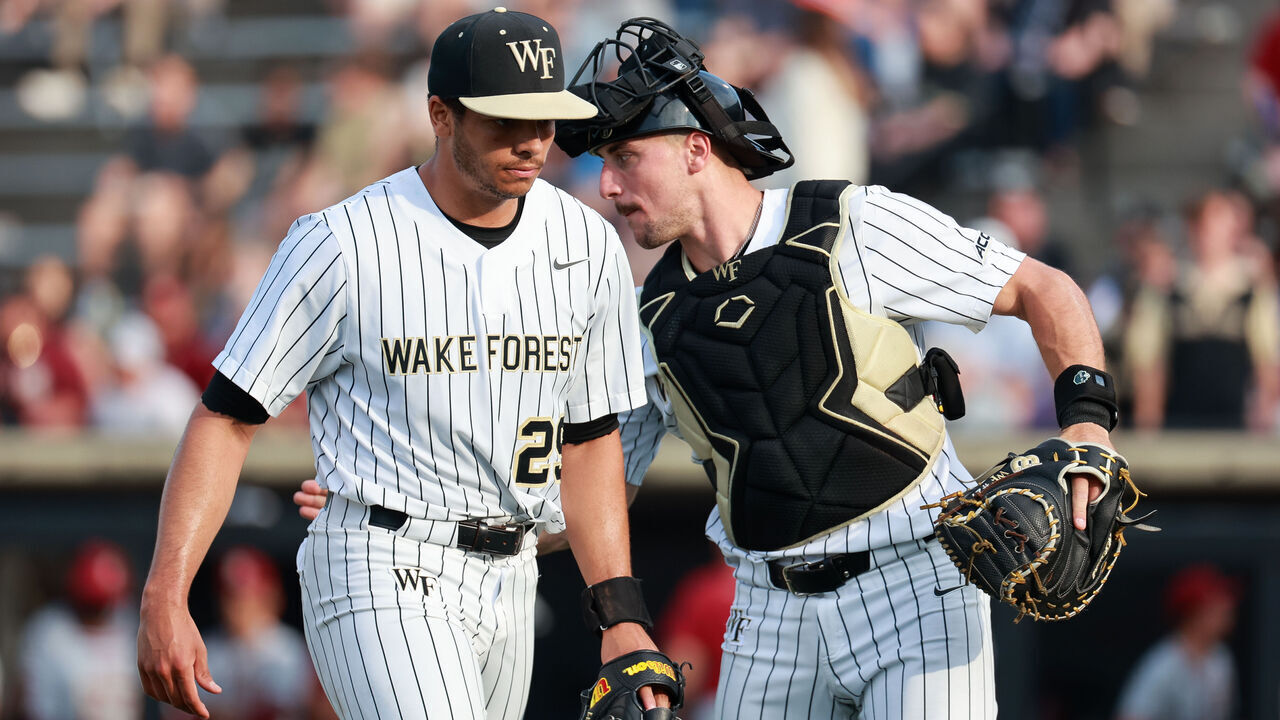 WINSTON SALEM, NORTH CAROLINA - APRIL 19: Cameron Gill #27 of the Wake Forest Demon Deacons taps Chase Burns #29 of the Wake Forest Demon Deacons after an inning against the Florida State Seminoles at David F. Couch Ballpark on April 19, 2024 in Winston Salem, North Carolina.