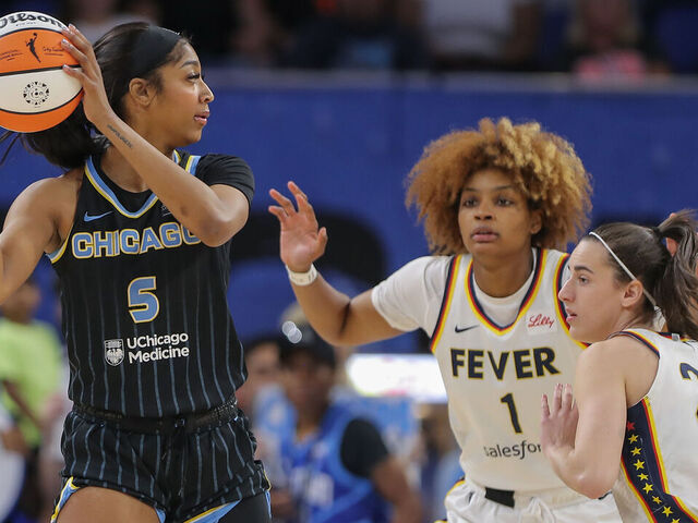 CHICAGO, IL - JUNE 23: Angel Reese #5 of the Chicago Sky is doubled teamed by Caitlin Clark #22 of the Indiana Fever and NaLyssa Smith #1 of the Indiana Fever during the first half on June 23, 2024 at Wintrust Arena in Chicago, Illinois.