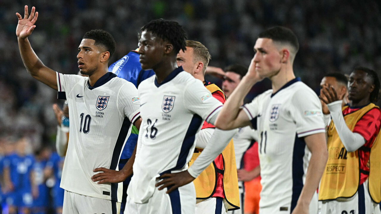 England's midfielder #10 Jude Bellingham (L) and teammates thanks fans after the UEFA Euro 2024 Group C football match between England and Slovenia at the Cologne Stadium in Cologne on June 25, 2024.