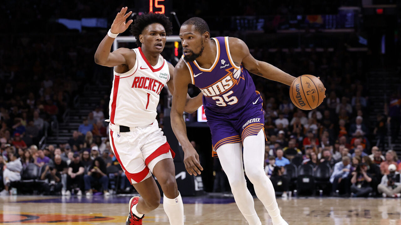 PHOENIX, ARIZONA - MARCH 02: Kevin Durant #35 of the Phoenix Suns drives against Amen Thompson #1 of the Houston Rockets during the game at Footprint Center on March 02, 2024 in Phoenix, Arizona. The Rockets defeated the Suns 118-109.