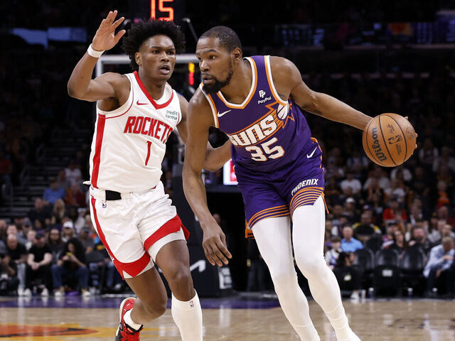 PHOENIX, ARIZONA - MARCH 02: Kevin Durant #35 of the Phoenix Suns drives against Amen Thompson #1 of the Houston Rockets during the game at Footprint Center on March 02, 2024 in Phoenix, Arizona. The Rockets defeated the Suns 118-109.