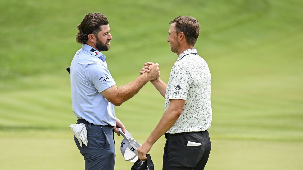 CROMWELL, CONNECTICUT - JUNE 22: Cameron Young smiles with Jordan Spieth on the 18th hole green after making a par putt to card an 11-under 59 round during the third round of the Travelers Championship at TPC River Highlands on June 22, 2024, in Cromwell, Connecticut.