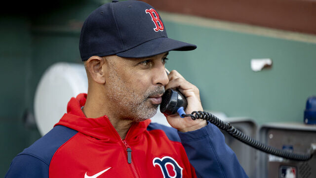 BOSTON, MA - JUNE 4: Manager Alex Cora #13 of the Boston Red Sox talks on the phone to the bullpen before a game against the Atlanta Braves on June 4, 2024 at Fenway Park in Boston, Massachusetts.