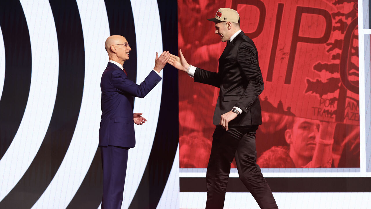 NEW YORK, NEW YORK - JUNE 26: Donovan Clingan (R) shakes hands with NBA commissioner Adam Silver (L) after being drafted seventh overall by the Portland Trailblazers during the first round of the 2024 NBA Draft at Barclays Center on June 26, 2024 in the Brooklyn borough of New York City.