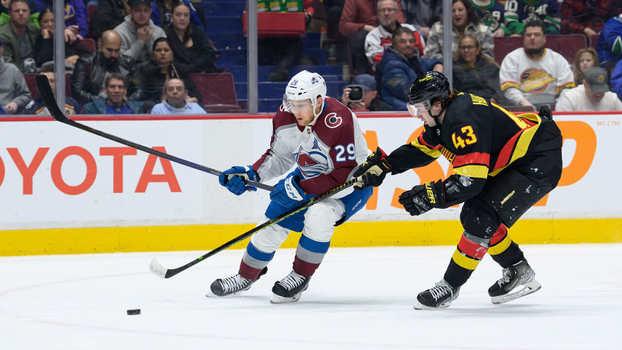 VANCOUVER, CANADA - JANUARY 20: Quinn Hughes #43 of the Vancouver Canucks defends against Nathan MacKinnon #29 of the Colorado Avalanche during the second period of their NHL game at Rogers Arena on January 20, 2023 in Vancouver, British Columbia, Canada.