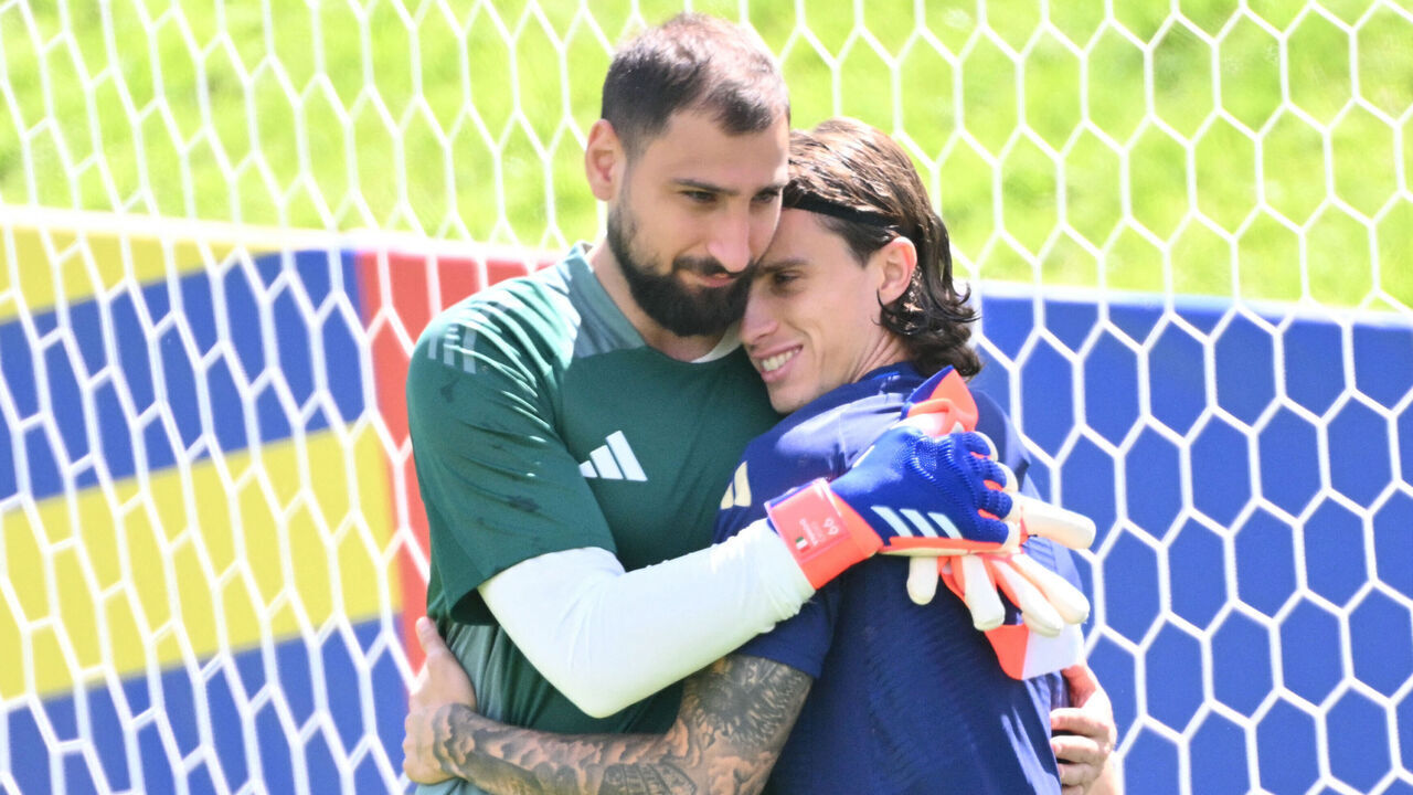 TOPSHOT - Italy's goalkeeper #01 Gianluigi Donnarumma embraces Italy's defender #05 Riccardo Calafiori during an MD-1 training session at the base camp in Iserlohn on June 28, 2024, on the eve of their UEFA Euro 2024 Round of 16 football match against Switzerland.