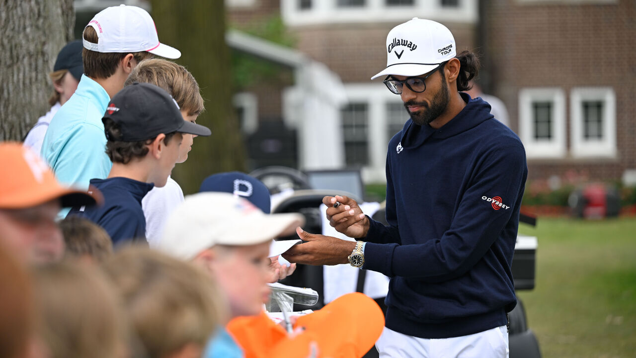 DETROIT, MICHIGAN - JUNE 28: Akshay Bhatia signs autographs for fans during the second round of the Rocket Mortgage Classic at Detroit Golf Club on June 28, 2024 in Detroit, Michigan.