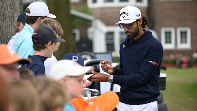 DETROIT, MICHIGAN - JUNE 28: Akshay Bhatia signs autographs for fans during the second round of the Rocket Mortgage Classic at Detroit Golf Club on June 28, 2024 in Detroit, Michigan.