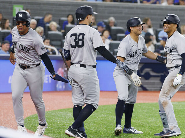 TORONTO, CANADA - JUNE 28: Juan Soto #22 of the New York Yankees celebrates with Anthony Volpe #11 and J.D. Davis #38 as they celebrate Soto's three run home in the sixth inning of their MLB game against the Toronto Blue Jays at Rogers Centre on June 28, 2024 in Toronto, Ontario, Canada.