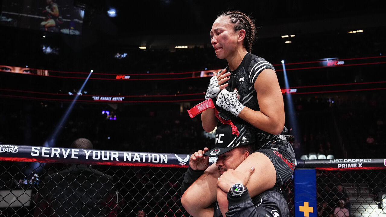 LAS VEGAS, NEVADA - JUNE 29: Michelle Waterson-Gomez is carried around the octagon by her husband Joshua Gomez after she announced her retirement following being defeated by Gillian Robertson of Canada in a strawweight fight during the UFC 303 event at T-Mobile Arena on June 29, 2024 in Las Vegas, Nevada.