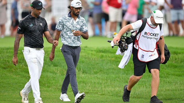 DETROIT, MICHIGAN - JUNE 29: Aaron Rai of England and Akshay Bhatia walk together along the third tee box during the third round of the Rocket Mortgage Classic at Detroit Golf Club on June 29, 2024 in Detroit, Michigan.
