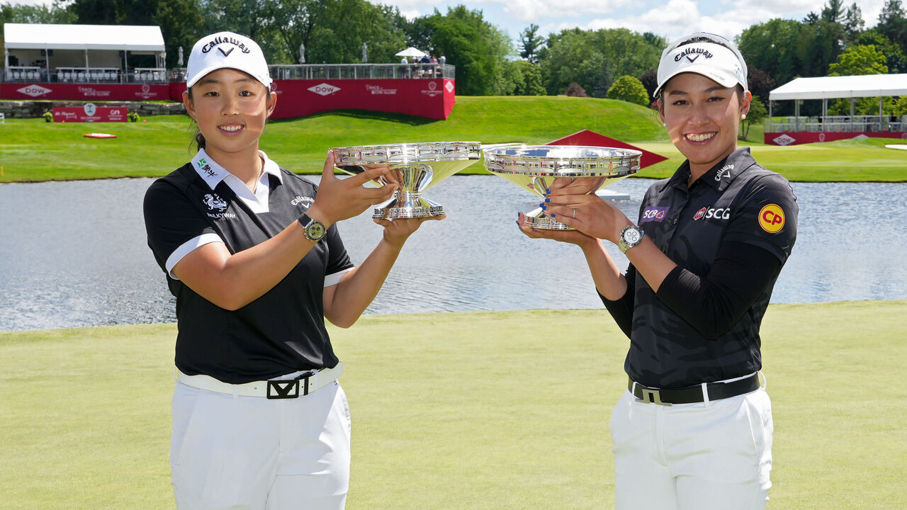 MIDLAND, MICHIGAN - JUNE 30: (EDITOR'S NOTE: This image was sent with alternate crop). Ruoning Yin of China (L) and Atthaya Thitikul of Thailand pose with the trophy after winning the Dow Championship at Midland Country Club on June 30, 2024 in Midland, Michigan.