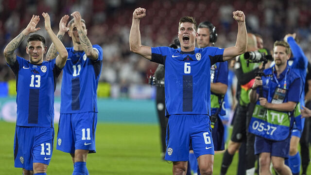 COLOGNE, GERMANY - JUNE 25: Slovenia's players celebrate qualifying for the knock-out stages on the pitch after the UEFA EURO 2024 Group C match between England and Slovenia at Cologne Stadium in Cologne, Germany on June 25, 2024.