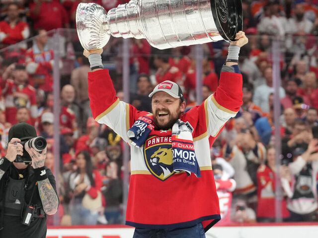 SUNRISE, FL - JUNE 24: Florida Panthers center Sam Reinhart (13) celebrates with the cup following game seven of the Stanley Cup Finals between the Edmonton Oilers and the Florida Panthers on Monday, June 24, 2024 at Amerant Bank Arena in Sunrise, Fla.