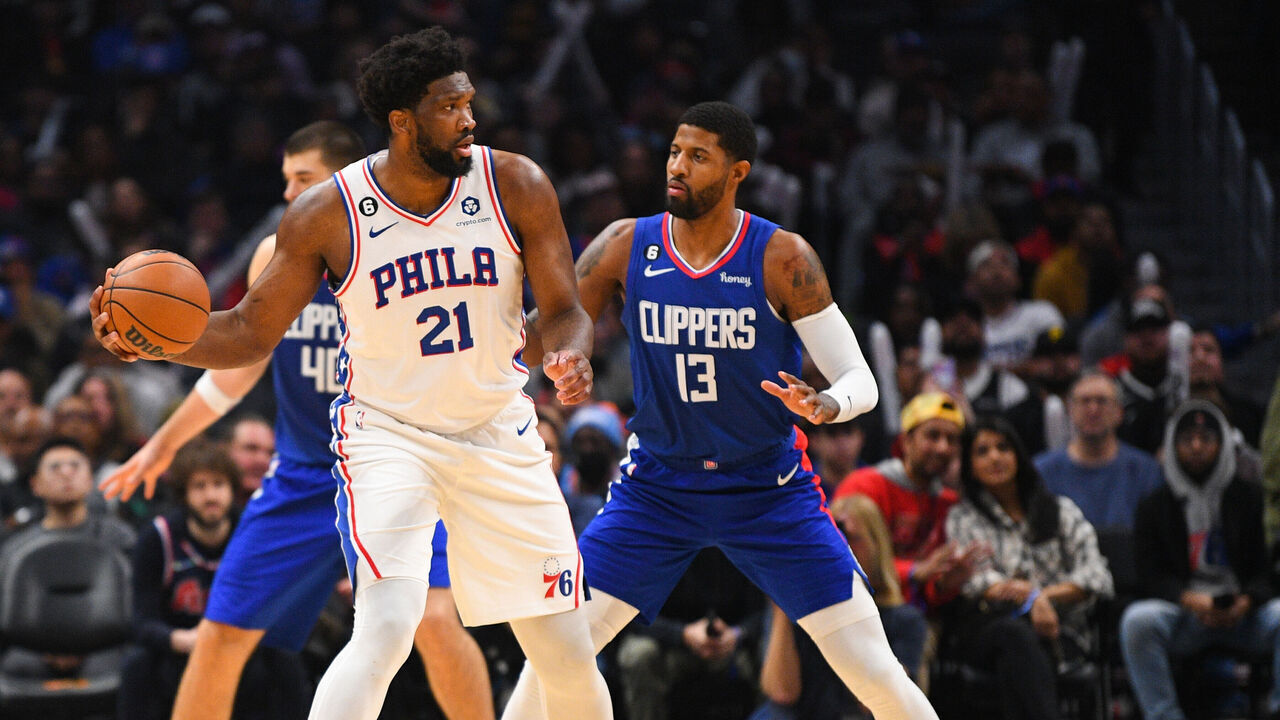 LOS ANGELES, CA - JANUARY 17: Philadelphia 76ers Center Joel Embiid (21) is guarded by Los Angeles Clippers Forward Paul George (13) during a NBA game between the Philadelphia 76ers and the Los Angeles Clippers on January 17, 2023 at Crypto.com Arena in Los Angeles, CA.