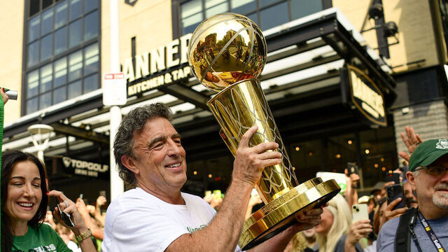 BOSTON, MASSACHUSETTS - JUNE 21: Owner Wyc Grousbeck of the Boston Celtics reacts as he holds the Larry O'Brien Championship Trophy during the 2024 Boston Celtics championship parade following their 2024 NBA Finals win on June 21, 2024 in Boston, Massachusetts.