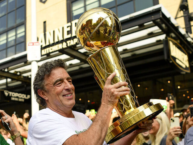 BOSTON, MASSACHUSETTS - JUNE 21: Owner Wyc Grousbeck of the Boston Celtics reacts as he holds the Larry O'Brien Championship Trophy during the 2024 Boston Celtics championship parade following their 2024 NBA Finals win on June 21, 2024 in Boston, Massachusetts.
