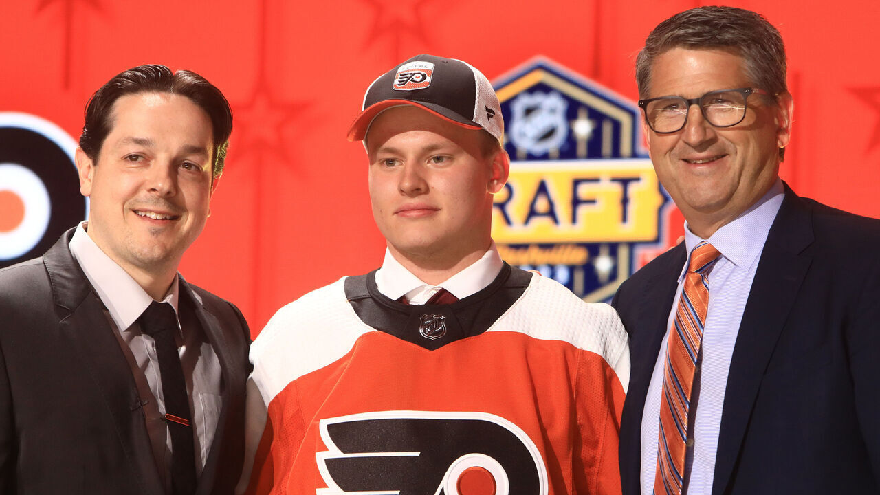 NASHVILLE, TN - JUNE 28: Matvei Michkov is shown with Daniel Briere and Keith Jones during the first round of the 2023 Upper Deck NHL Draft, held on June 28, 2023, at Bridgestone Arena in Nashville, Tennessee.