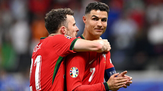 FRANKFURT AM MAIN, GERMANY - JULY 01: Diogo Jota and Cristiano Ronaldo of Portugal celebrate following the team's victory in the penalty shoot out during the UEFA EURO 2024 round of 16 match between Portugal and Slovenia at Frankfurt Arena on July 01, 2024 in Frankfurt am Main, Germany.