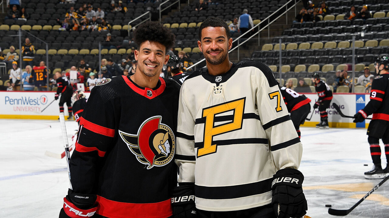 PITTSBURGH, PA - JANUARY 20: Brothers Mathieu Joseph #21 of the Ottawa Senators and Pierre-Olivier Joseph #73 of the Pittsburgh Penguins pose for a photo before the game at PPG PAINTS Arena on January 20, 2023 in Pittsburgh, Pennsylvania.