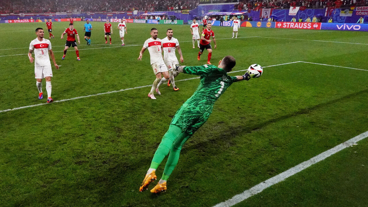 LEIPZIG, GERMANY - JULY 02: (EDITORS NOTE: Image was captured using a remote netcam.) Mert Gunok of Turkiye saves the headed shot of Christoph Baumgartner of Austria (not pictured) during the UEFA EURO 2024 round of 16 match between Austria and Turkiye at Football Stadium Leipzig on July 02, 2024 in Leipzig, Germany.