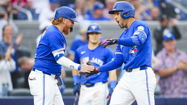 TORONTO, ON - JULY 2: George Springer #4 of the Toronto Blue Jays celebrates his three-run home run with Justin Turner #2 against the Houston Astros during the third inning in their MLB game at the Rogers Centre on July 2, 2024 in Toronto, Ontario, Canada.