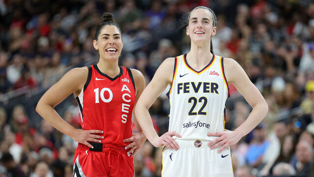 LAS VEGAS, NEVADA - JULY 02: Kelsey Plum #10 of the Las Vegas Aces and Caitlin Clark #22 of the Indiana Fever talk on the court while an Aces player shoots free throws in the fourth quarter of their game at T-Mobile Arena on July 02, 2024 in Las Vegas, Nevada. The Aces defeated the Fever 88-69.