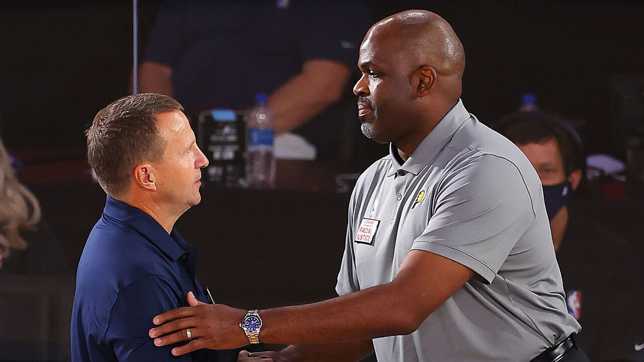 LAKE BUENA VISTA, FLORIDA - AUGUST 03: Nate McMillan of the Indiana Pacers and Scott Brooks of the Washington Wizards shake hands after the game at Visa Athletic Center at ESPN Wide World Of Sports Complex on August 03, 2020 in Lake Buena Vista, Florida.