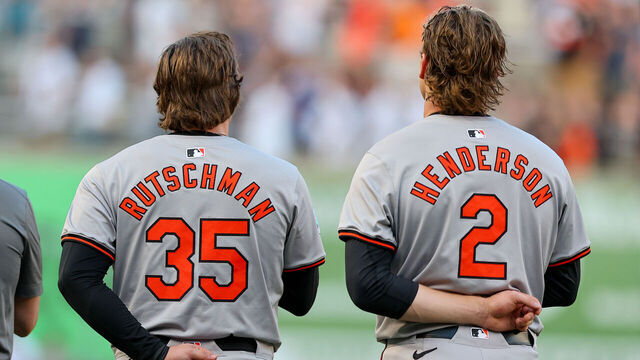 BRONX, NY - JUNE 18: Adley Rutschman #35 of the Baltimore Orioles and Gunnar Henderson #2 during the National Anthem on the field prior to the game against the New York Yankees on June 18, 2024 at Yankee Stadium in Bronx, New York.
