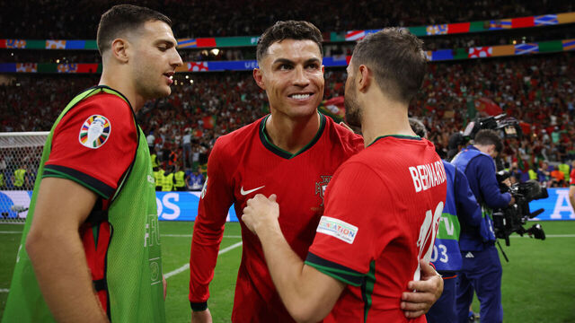 FRANKFURT AM MAIN, GERMANY - JULY 01: Cristiano Ronaldo of Portugal celebrates with teammate Bernardo Silva following the team's victory in the penalty shoot out during the UEFA EURO 2024 round of 16 match between Portugal and Slovenia at Frankfurt Arena on July 01, 2024 in Frankfurt am Main, Germany.