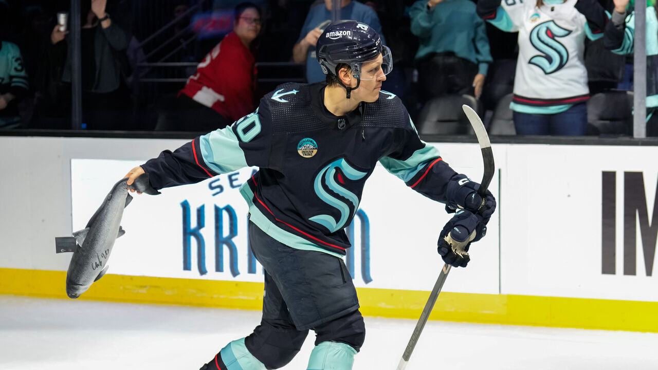 SEATTLE, WASHINGTON - MARCH 26: Eeli Tolvanen #20 of the Seattle Kraken throws a toy stuffed fish to the crowd after a game against the Anaheim Ducks at Climate Pledge Arena on March 26, 2024 in Seattle, Washington.