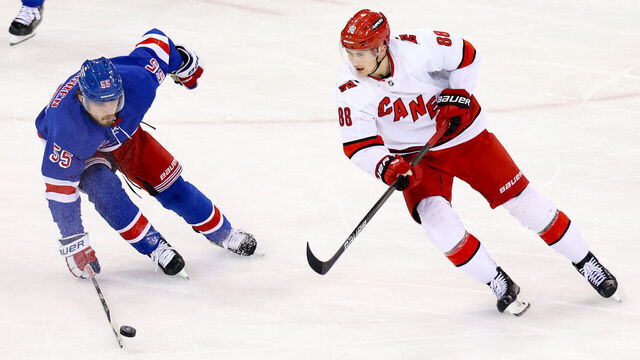 NEW YORK, NY - JANUARY 02: New York Rangers Defenseman Ryan Lindgren (55) blocks a pass by Carolina Hurricanes Right Wing Martin Necas (88) during the third period of the National Hockey League game between the Carolina Hurricanes and the New York Rangers on January 2, 2024 at Madison Square Garden in New York, NY.